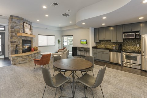 a living room with a table and a fire place